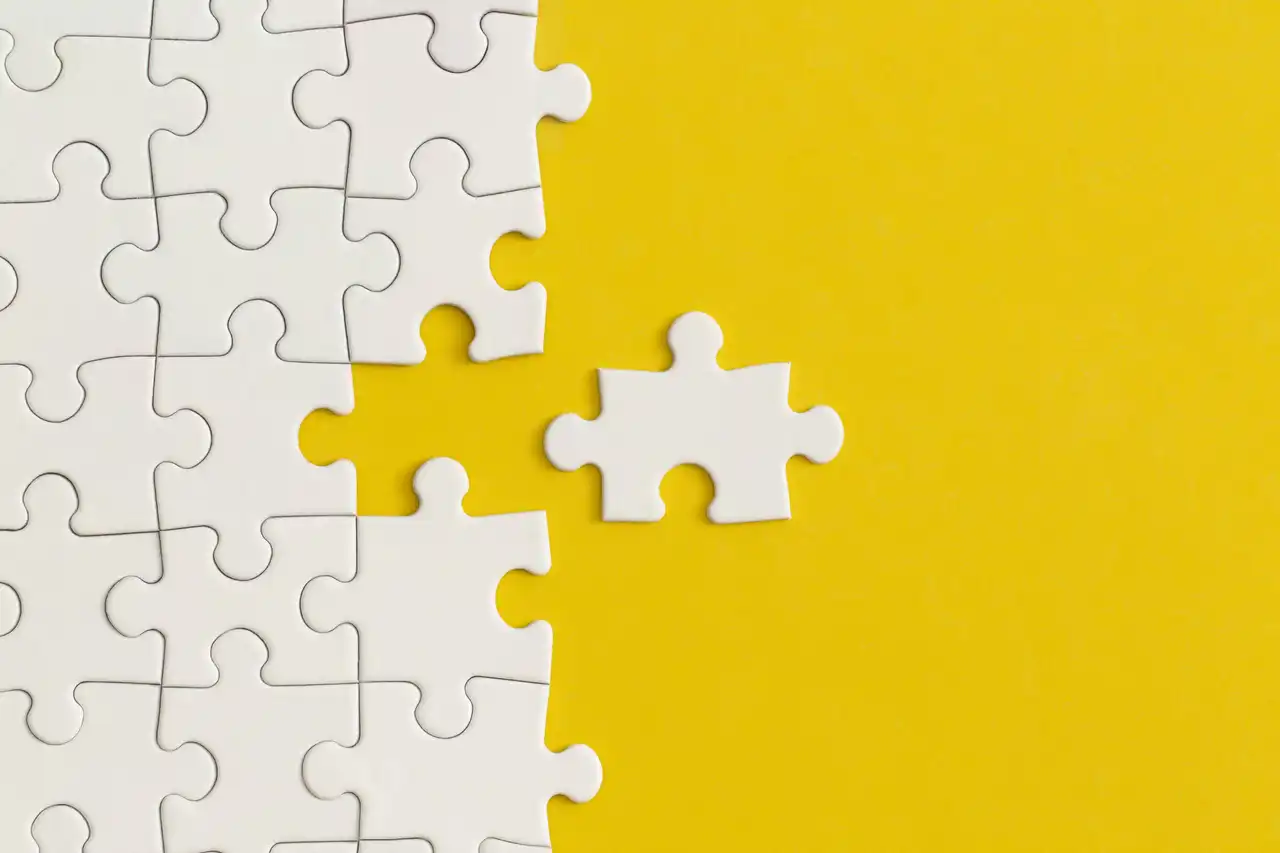 White details of puzzle on yellow background. Business strategy, teamwork.